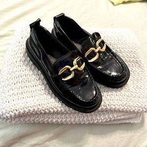 Black dress shoes with gold linked chain